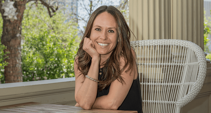Amber Vilhauer smiling, with one hand in her chin