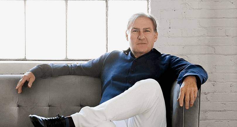 Mark B. Murphy sitting back, relaxed, on a couch