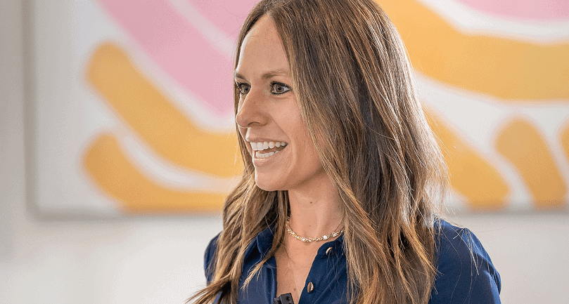 Amber Vilhauer on stage speaking on a live event